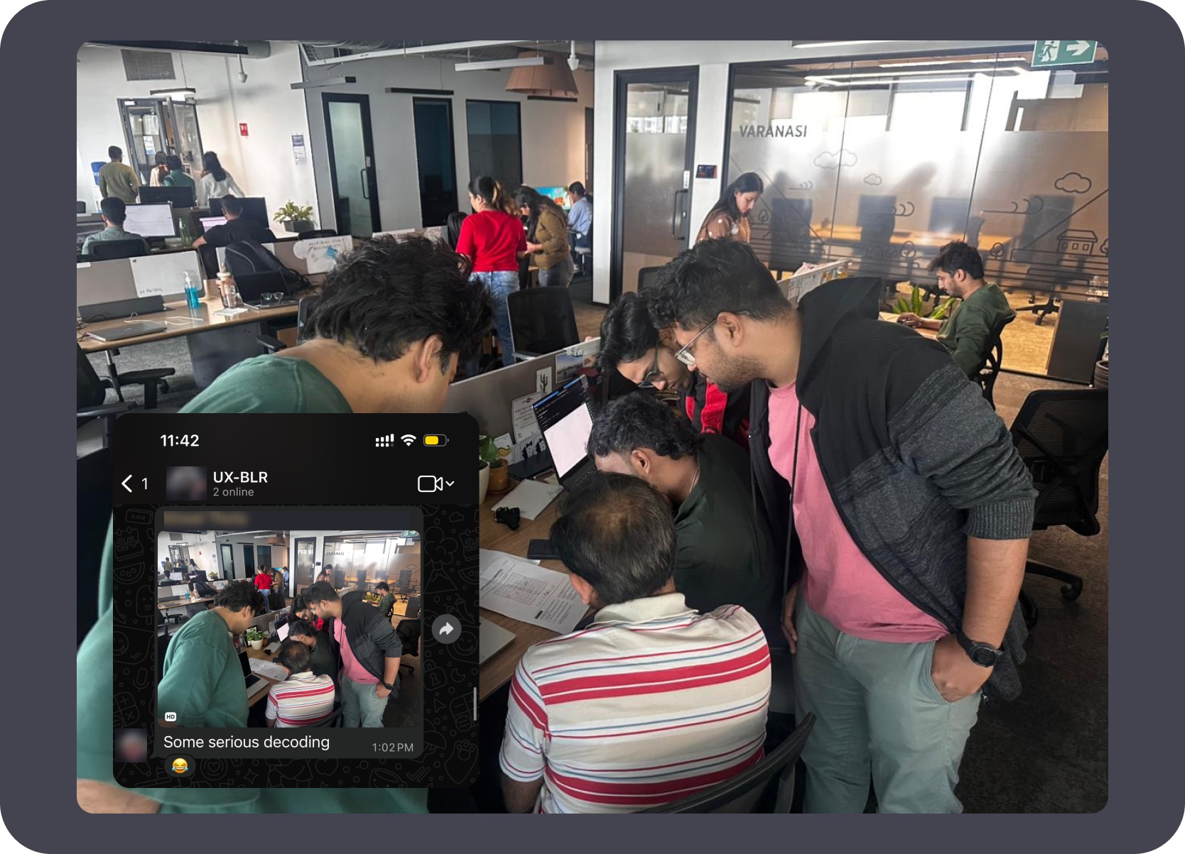 Team huddled around a screen decoding the Secret Santa puzzle