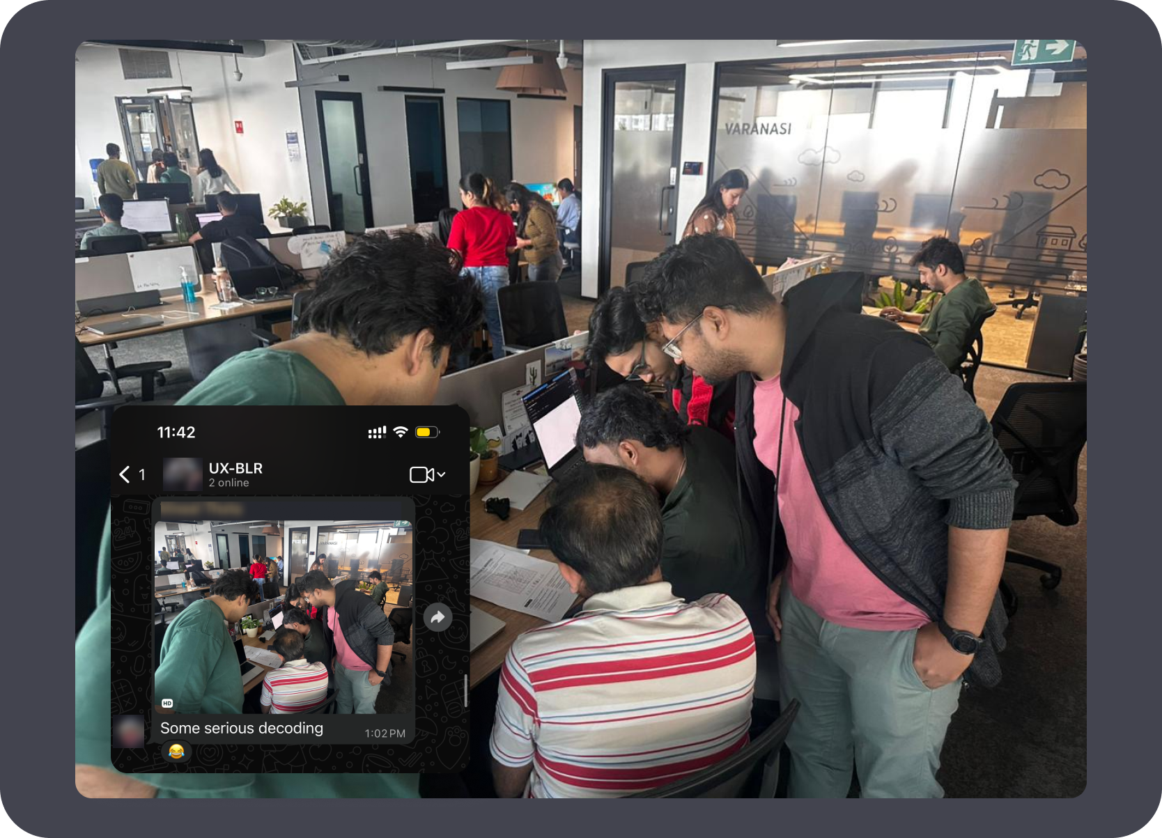 Team huddled around a screen decoding the Secret Santa puzzle